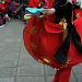 A woman flares her traditional Xinjiang dress.